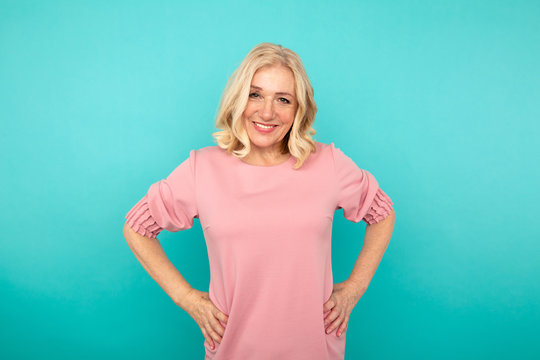 Portrait Of Attractive Mature Woman Smiling And Putting Her Hands On Her Waist