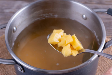 Cooking soup. Chopped potatoes in soup