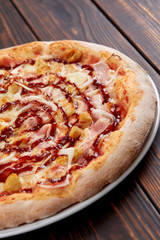 tasty pizza on the wooden background