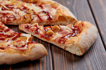 tasty pizza on the wooden background