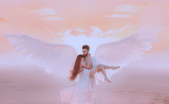 Strong muscular male angel holds hug fragile innocent woman in arms. concept protection prayer security helper keeper love faith help religion. Fine art imagery sky. Girl and handsome man embracing