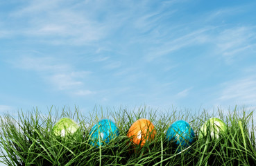 Row of Easter eggs in Fresh Green Grass