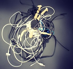 Jumbled mess of cords, wires, headphones