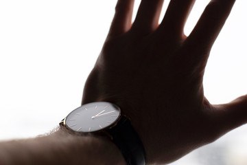 hand pressed against window watch on wrist