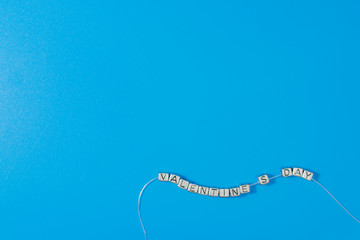 The inscription Valentine's day laid out in small letters on a blue background