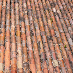 Roof of red old grunge weathered tiles.
