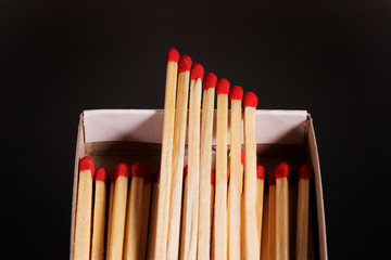 box of matches with matches on a black background