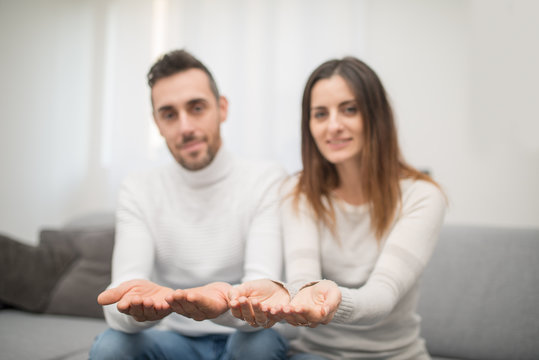 Couple showing their open hands, copy space to place a product