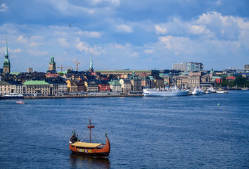 Obraz premium Stylized Viking ship Drakkar on the background of the panoramic view of Stockholm. Sweden