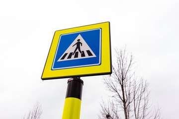 Pedestrian crossing traffic sign in neon yellow and blue colors in the Netherlands