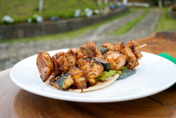 Chicken skewers fried in sesame oil, cuisine with oriental flavor in Guatemala, Central America.