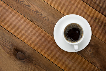 Coffee cup isolated on wooden table. Top view, flat lay coffee drink with copy space.