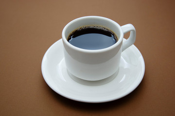 Coffee cup isolated on brown table. Coffee drink with copy space.