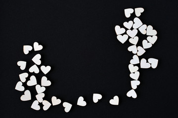arbitrarily scattered white hearts on black background. free space for advertising, logo, inscriptions