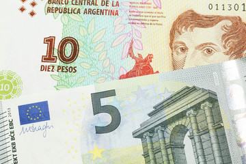 A ten peso bill from Argentina, close up in macro with a red, five Euro European bank note