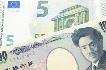 A one thousand Japanese yen bank note, close up in macro with a five Euro European bank note