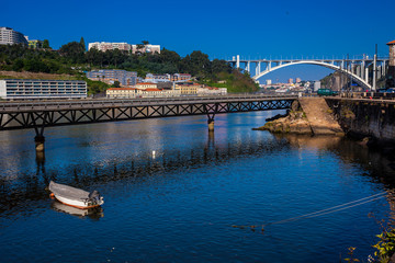 View of the Duoro River and the Cais das Pedras Viaduct in a beautiful early spring day at Porto City in Portugal