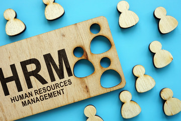 HRM human resources management concept. Wooden figures on the blue background. - obrazy, fototapety, plakaty