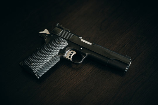 1911 Handgun Pistol on Wood Grain
