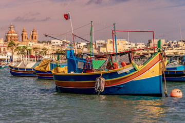 A luzzu is a traditional fishing boat from the Maltese islands. Painted in bright colours, luzzus have existed sin