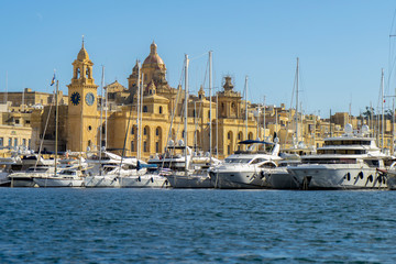 Sailboats sitting in the port in front of old city