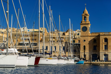 Sailboats sitting in the port in front of old city