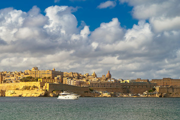 Fototapeta na wymiar City of Birgu in Malta with Fort St. Angelo and Vittoriosa Yacht Marina in the Grand Harbour 