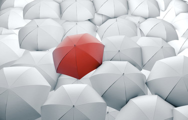 Red umbrella in mass of white umbrellas