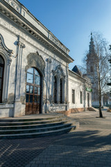 Old canteen building with the calvinist church in the background in Szabadszallas, Hungary