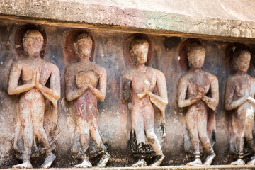 Walking Buddha image at Wat Mahathat. The base of the main chedi is decorated with relief-stucco of 168 Buddhist disciples walking with their hands clasped together. Sukhothai Historic Park