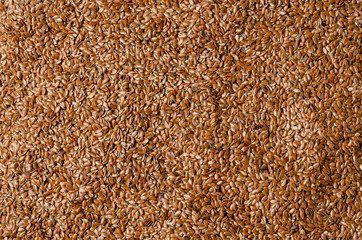 Brown flax seed background. Linen background. Texture.