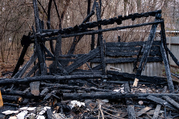 Consequences of fire. Completely burnt wooden house