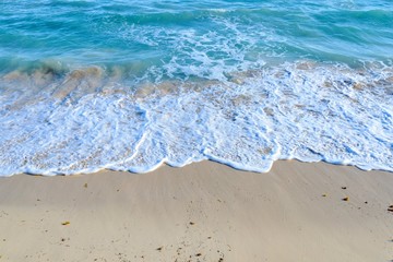 Fototapeta na wymiar Wave on a sandy beach in summer