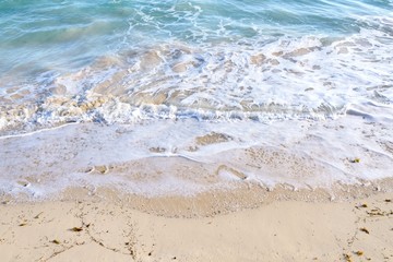 Wave on a sandy beach in summer
