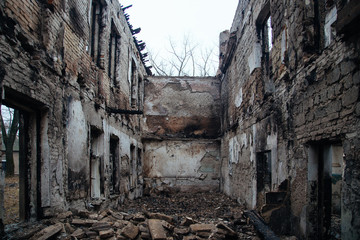 Fototapeta premium Completely burnt interiors and collapsed roof of the house after fire