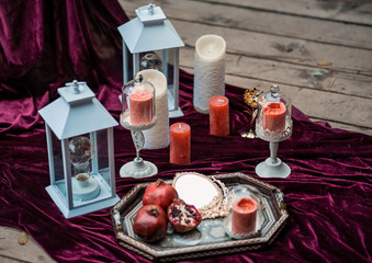 wedding invitation card, wax seal, vase, candles, red Garnet, flowers. Wedding calligraphy vintage top view