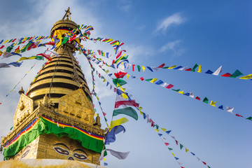 Prayer flags at the golden tower of the Swayambhunath stupa in Kathmandu, Nepal