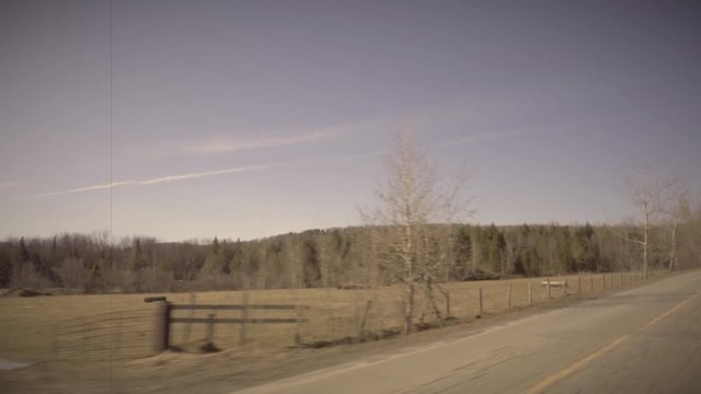 Moving on Country Road in Spring. Trees, Field, Fencing and Snow. Vintage Effect, 8mm, 4K