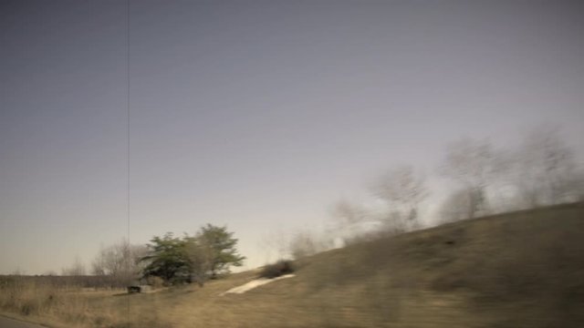 View on Edge of Country Road in Spring. Trees and Field. Vintage Effect, 8mm, 4K