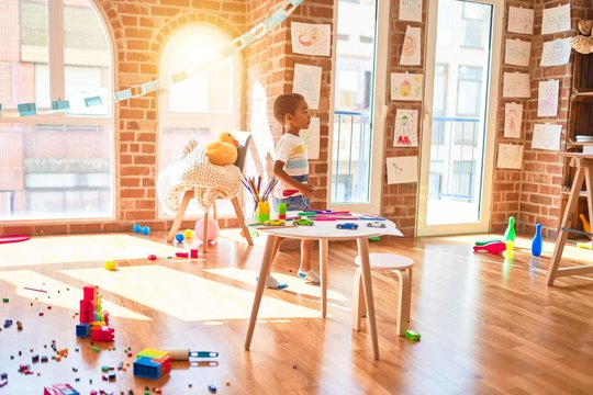 Beautiful african american toddler playing bowling at kindergarten