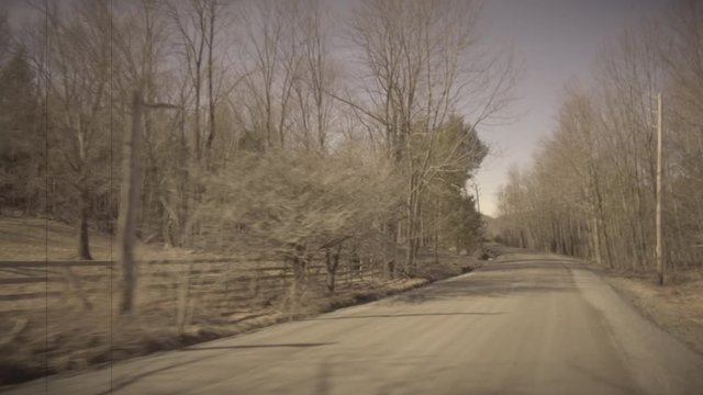 Moving on Country Road in Spring. Trees, Field, Fencing and Snow. Vintage Effect, 8mm, 4K