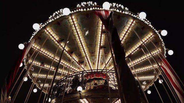 Bright carousel with lights rolls the children. Timelapse. Christmas night.