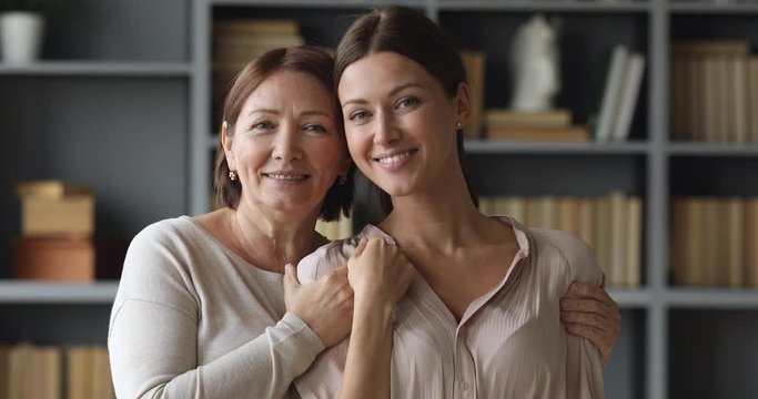 Attractive similar two age generations women family posing for portrait