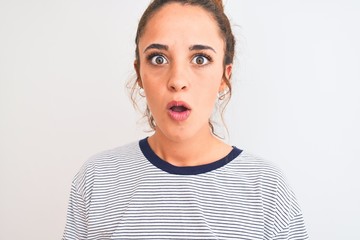 Young redhead modern woman wearing a bun over isolated background scared in shock with a surprise face, afraid and excited with fear expression