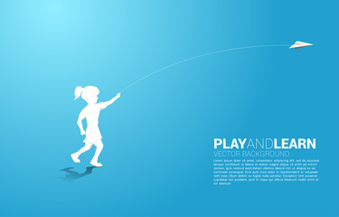silhouette of girl running to throw out origami paper airplane. Concept of children play and learn.