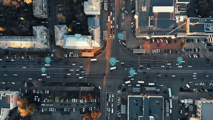 Aerial view of city intersection with many cars and GPS navigation system symbols. Autonomous driverless vehicles in city traffic. Future transportation concept. - obrazy, fototapety, plakaty
