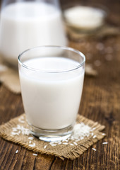 Vintage wooden table with Rice Milk (selective focus; close-up shot)