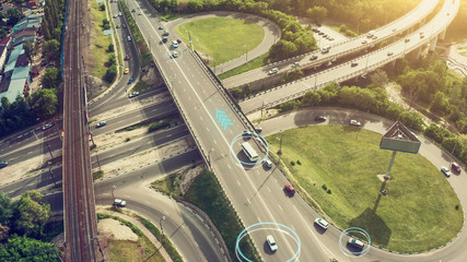 Autonomous Self Driving Cars Concept. Aerial view of cars and buses moving on city intersection and...