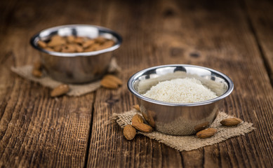 Portion of healthy Ground Almonds on an old wooden table (selective focus; close-up shot)