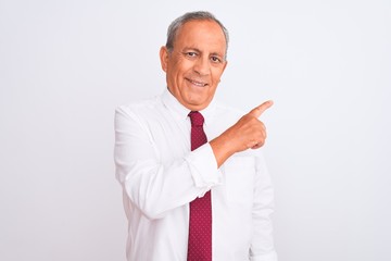 Senior grey-haired businessman wearing elegant tie over isolated white background cheerful with a smile of face pointing with hand and finger up to the side with happy and natural expression on face